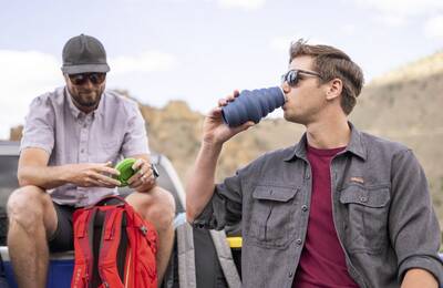 a collapsible water bottle being sipped from